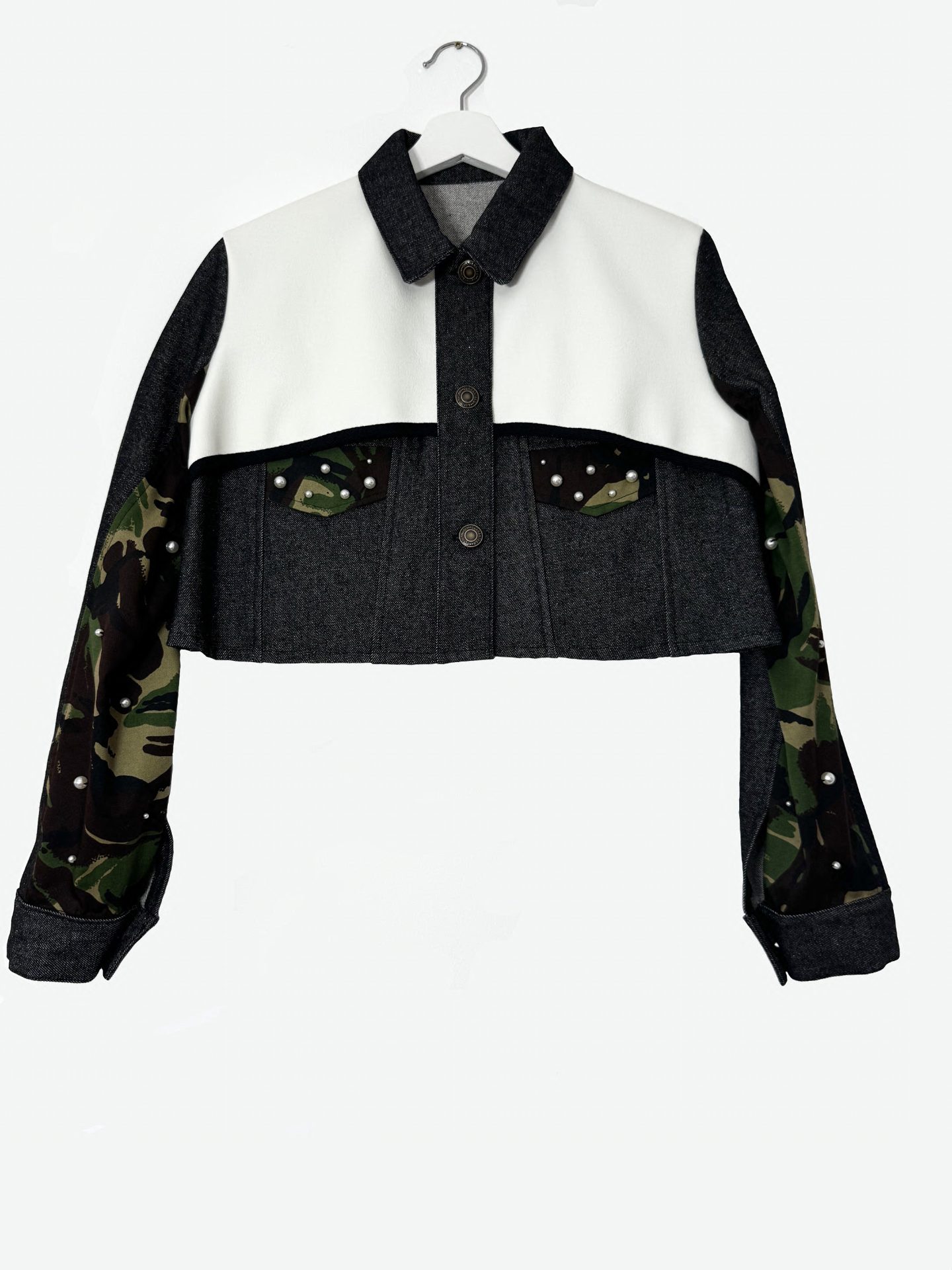 The Pearl Armour Jacket — cropped black denim with white faux leather yoke, camo sleeves and pearl pockets